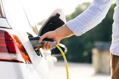 man charging an EV