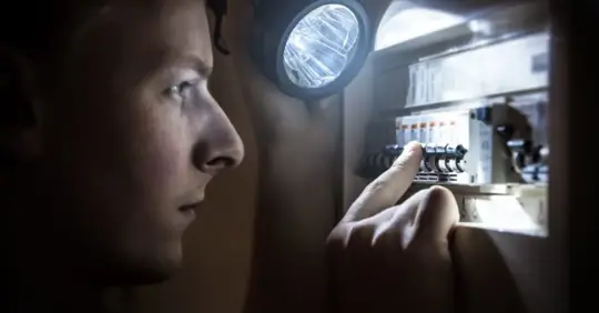 man checking electrical panel